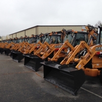 Over 100 CASE backhoe loaders with McLaren Nu-Air DT solid cushion tires lined up for CSX Transportation